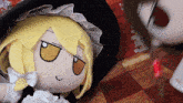 a stuffed doll with yellow hair and a hat