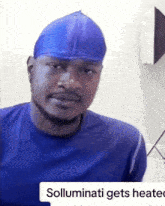 a man wearing a blue shirt and a blue hat with the words solluminati gets heated on the bottom