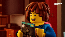 a lego character is holding a book that says ' a journey of a ninja ' on the cover