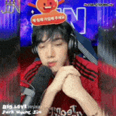a man wearing headphones is sitting in front of a microphone that says t98 strong