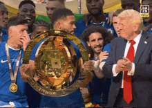 a man in a suit holds a trophy that says world cup