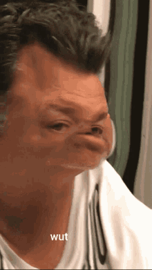 a close up of a man 's face with the word wut written below it