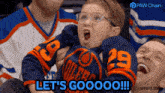 a young boy wearing an edmonton oilers jersey says let 's goooo !!!