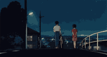 a man riding a bike stands next to a woman in a red shirt