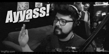 a man wearing glasses and headphones says ayyass