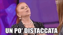 a woman with red hair and a pearl necklace says un po ' distaccata .
