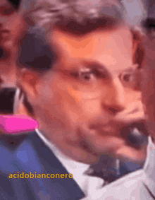 a close up of a man 's face with the words acidobianconero above him