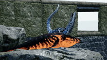 a blue and orange dinosaur laying on a rock near a window