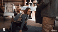 a woman is kneeling down in front of a man with bnxp written on the bottom