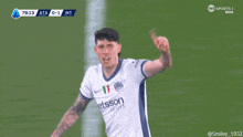 a soccer player wears a jersey that says etason on the front