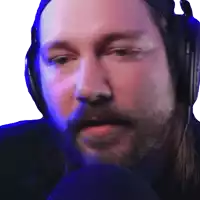 a man with a beard and headphones looks at the camera