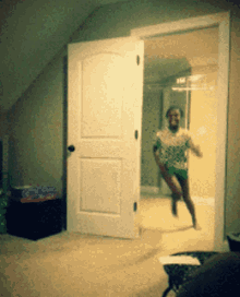 a person in a green shirt is running through a door