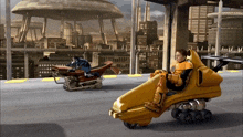 a man is riding a yellow vehicle while another man rides a motorcycle