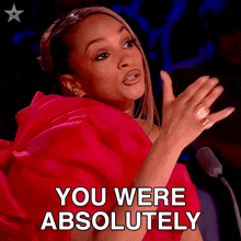 a woman in a red dress is clapping and says you were absolutely