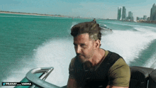 a man is riding a boat in the ocean with a watermark that says pranay varma