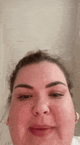 a close up of a woman 's face with the word this visible in the background