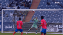 soccer players playing in front of a sign that says ssc on it