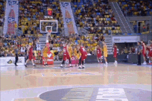 a basketball game is being played in front of a crowd with a scoreboard that says 21:31