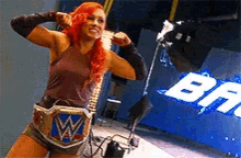 a woman with red hair wearing a w belt