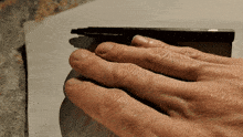 a close up of a person 's hand with a pen in it