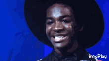 a man wearing a black hat and a bow tie is smiling with imgplay displayed in the corner