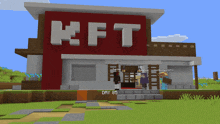 a minecraft building with kft written on the front