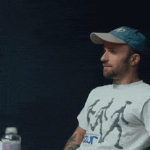 a man wearing a hat and a t-shirt that says ' jazz ' on it