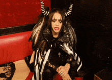a woman in a black and white costume with horns