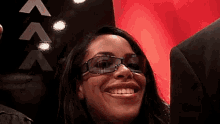 a woman wearing sunglasses is smiling for the camera .