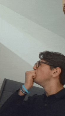 a man wearing glasses and a blue wristband that says i love you