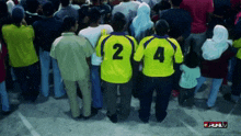 a group of people wearing yellow jerseys with the number 2 and 4