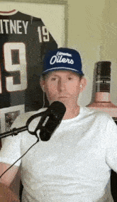 a man wearing a hat that says edmonton oilers