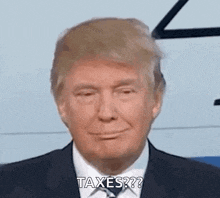 donald trump is wearing a suit and tie and smiling while asking about taxes .
