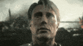 a close up of a man 's face with a serious look on his face