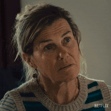 a close up of a woman 's face with the word netflix on the bottom right