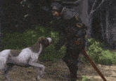 a man standing next to a brown and white dog with a sword