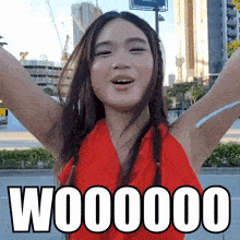 a woman in a red dress with her arms outstretched and the word w000000 written below her