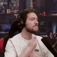 a man wearing headphones and a fila t-shirt