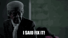 a woman wearing a hat and tie says " i said fix it "