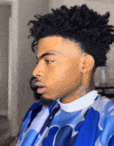 a man with dreadlocks has a tattoo on his forehead that says constance