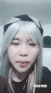 a woman wearing a wig and headphones is looking at the camera .