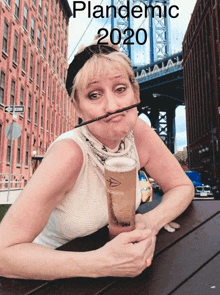 a woman sitting at a table holding a glass of beer with a straw in her mouth and the words pandemic 2020 above her