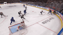 a hockey game is being played on a rink with uber eats advertisements on the boards