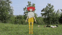 a girl with red hair is standing in a grassy field