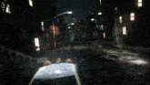 a police car is parked in a dark city street