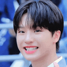 a close up of a young man 's face with a pink lip and white teeth