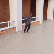 a man walking barefoot in front of a building