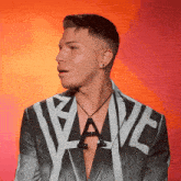 a man is wearing a jacket with the word wave on it