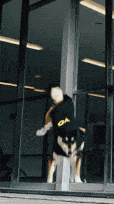 a dog wearing a black jacket with the letter oa on the front