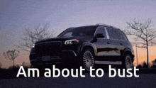 a black suv is parked on the side of the road with the caption " am about to bust "